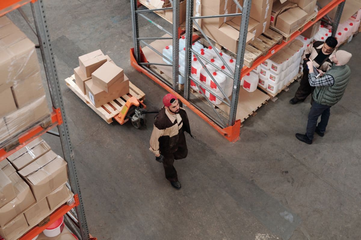 Warehouse team moving palletised cargo in a storage facility